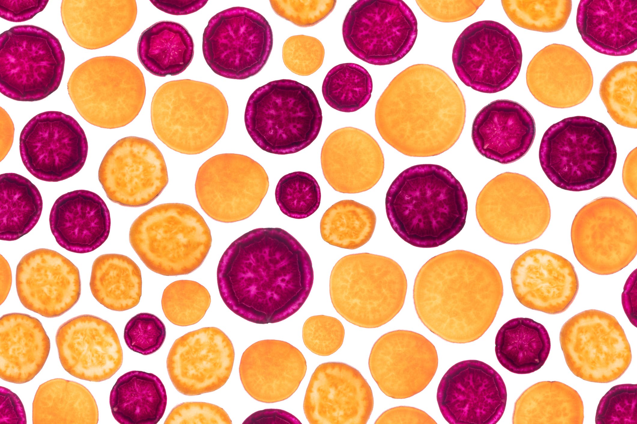 Sweet Potato Slices on White Background Back Lit Pattern Full Frame Studio Shot.