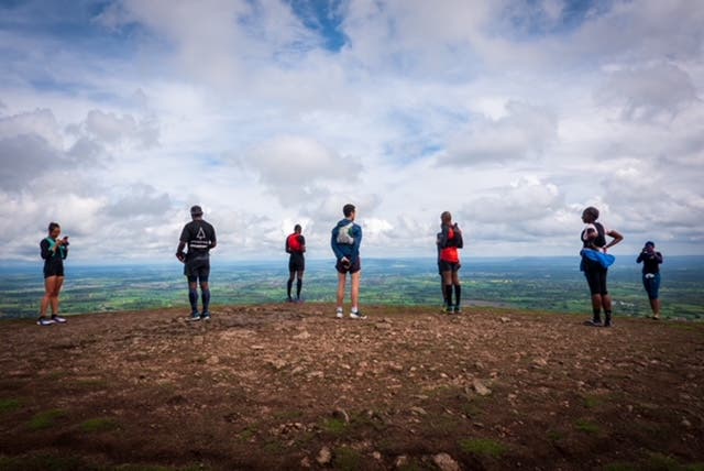 Group of runners standing on a ridge