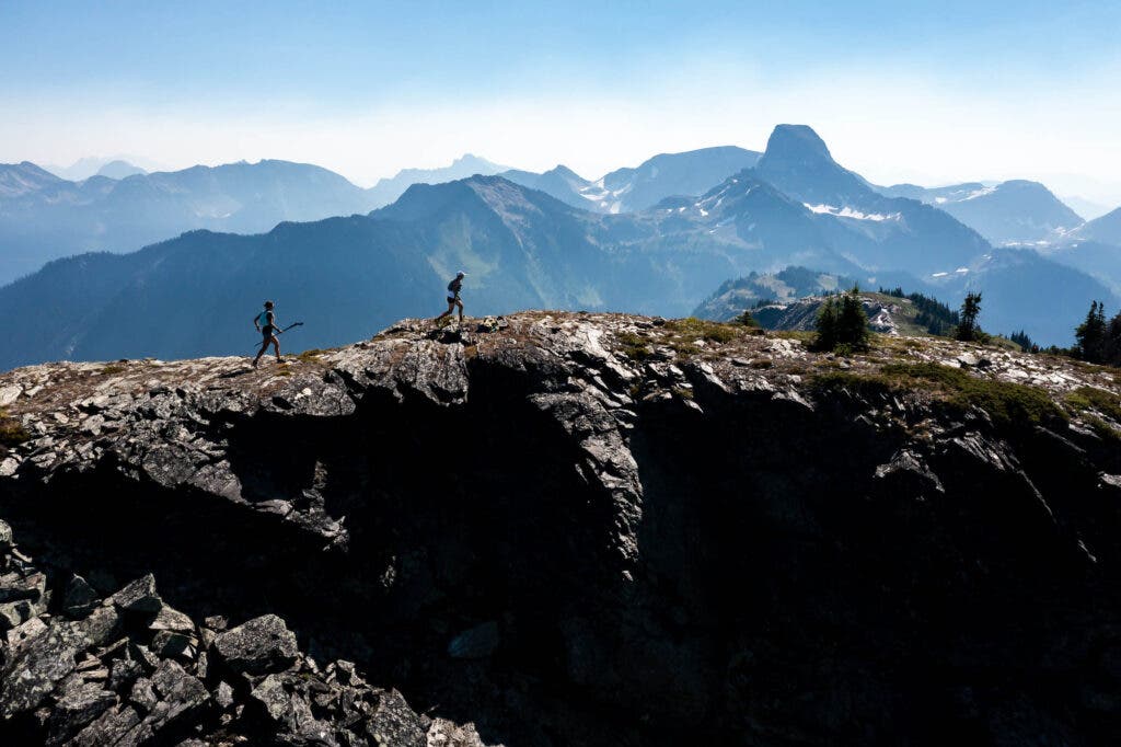 two runners are following a ridge