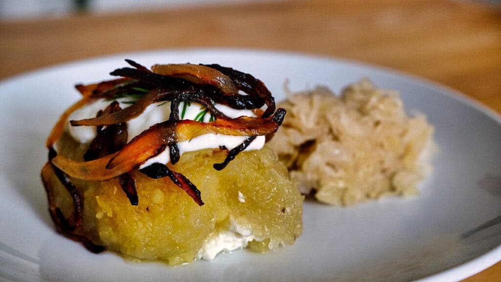 Lithuanian meat dumplings plated with onions