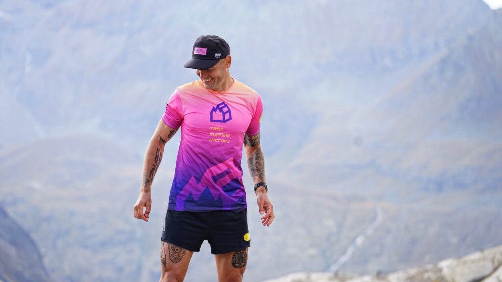 Athlete smiles in a hat and a pink shirt