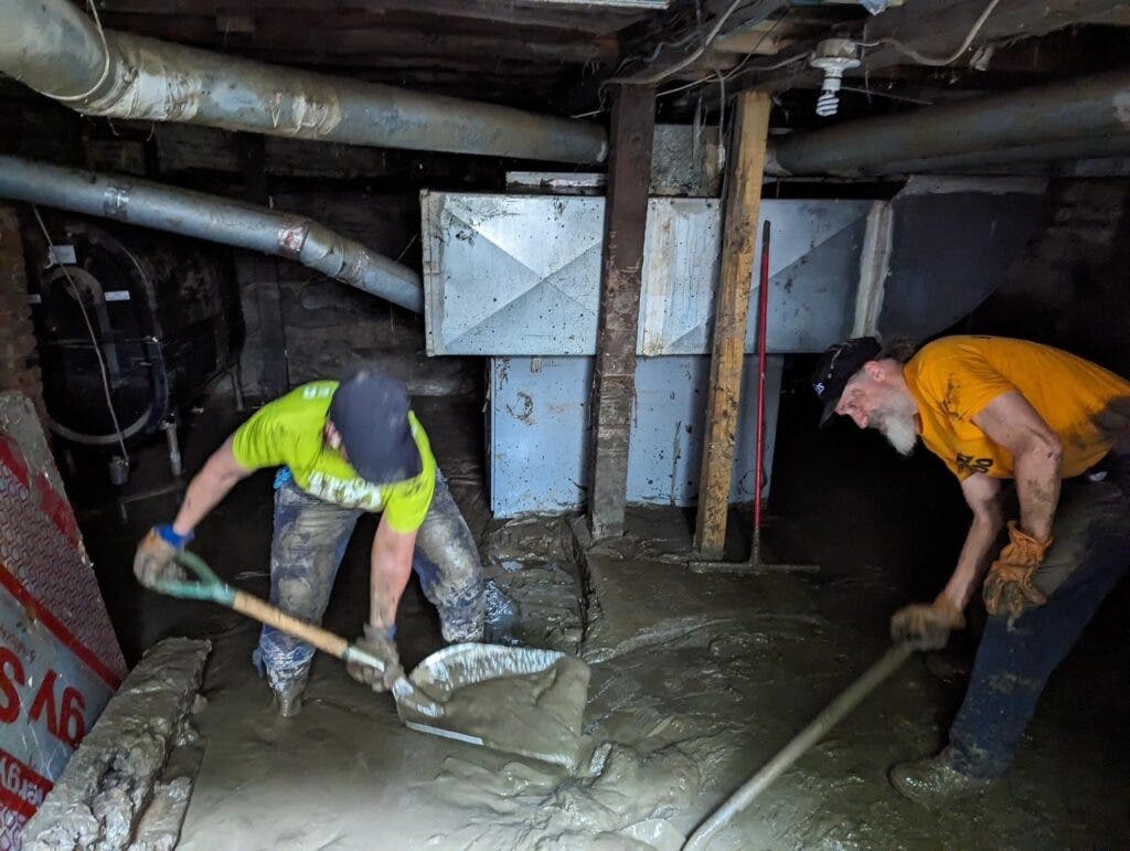 Vermont 100 volunteers mucking out a basement