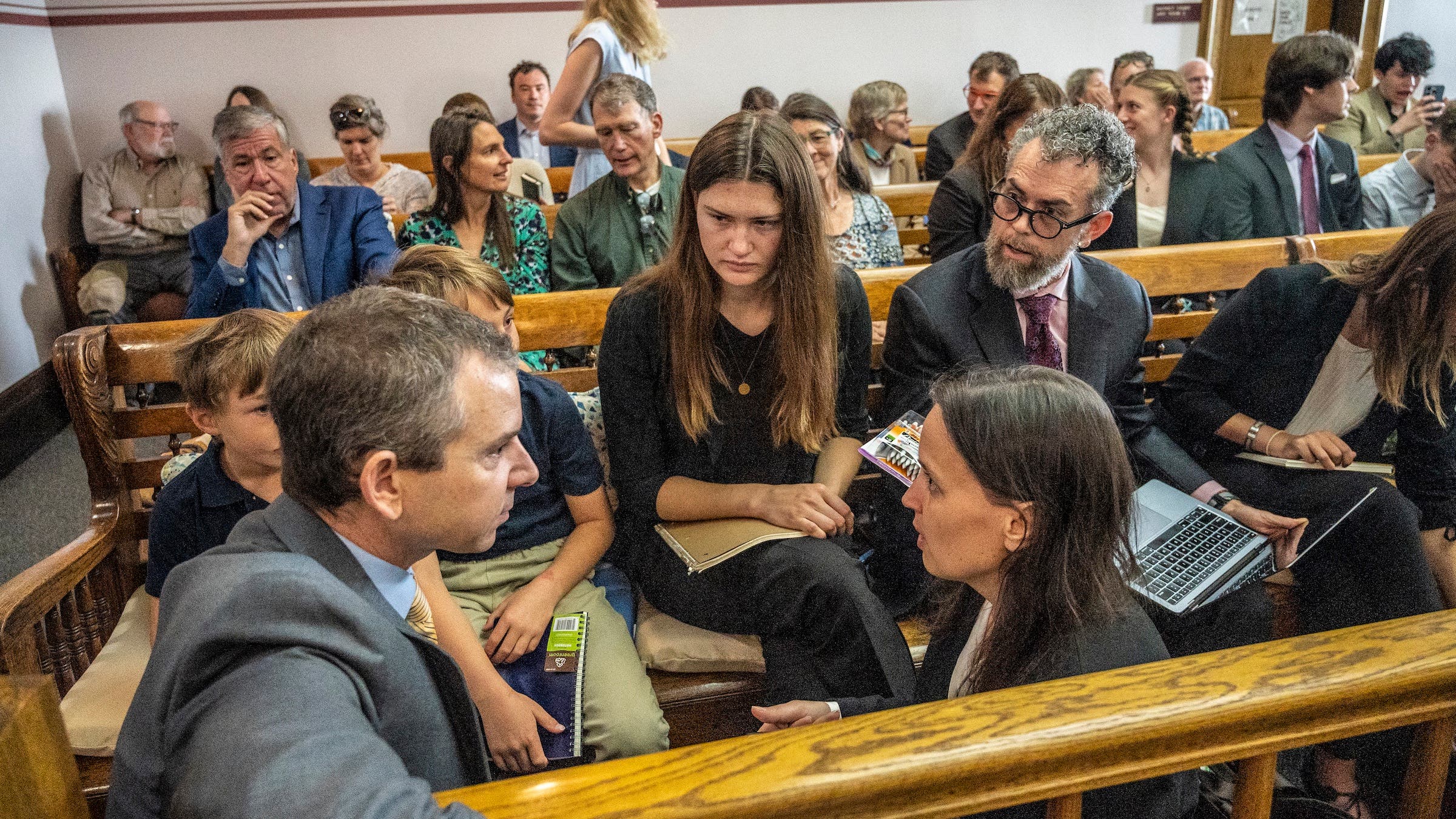 A group talks in a courtroom about climate action.