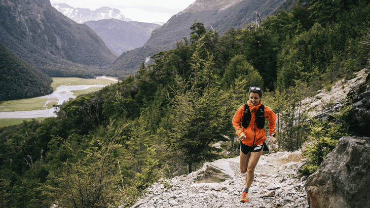 Ruth Croft running on a rocky trail above a river through a gorge.
