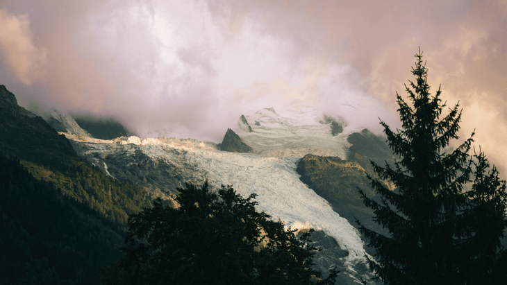 Photograph of Mont Blanc at dusk with moody clouds overhead.
